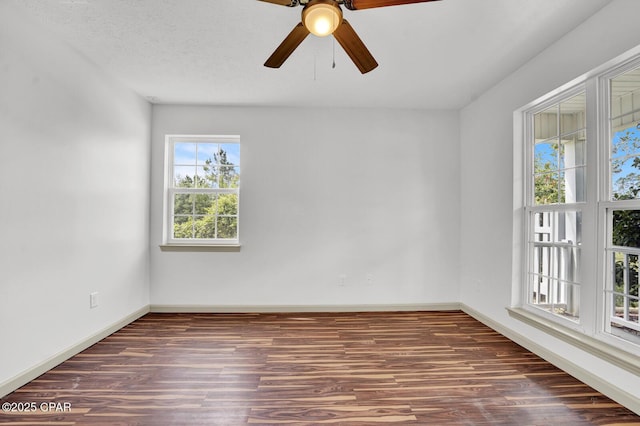 8508 S Holland Rd, Southport, FL 32409 - empty room with wood finished floors, a ceiling fan, and baseboards