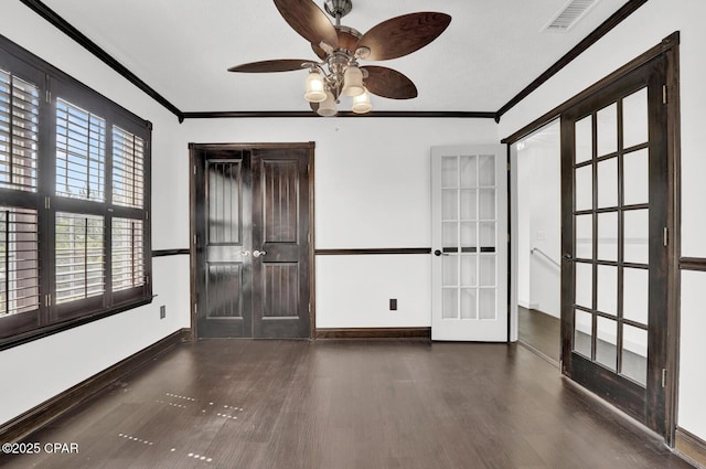 8508 S Holland Rd, Southport, FL 32409 - empty room featuring wood finished floors, baseboards, a ceiling fan, crown molding, and french doors