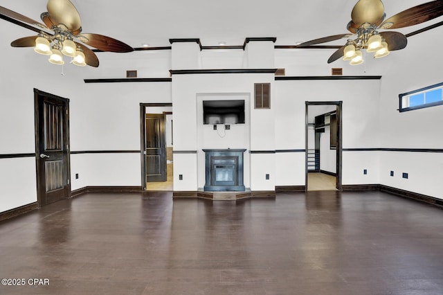 8508 S Holland Rd, Southport, FL 32409 - unfurnished living room with a ceiling fan, a glass covered fireplace, and wood finished floors
