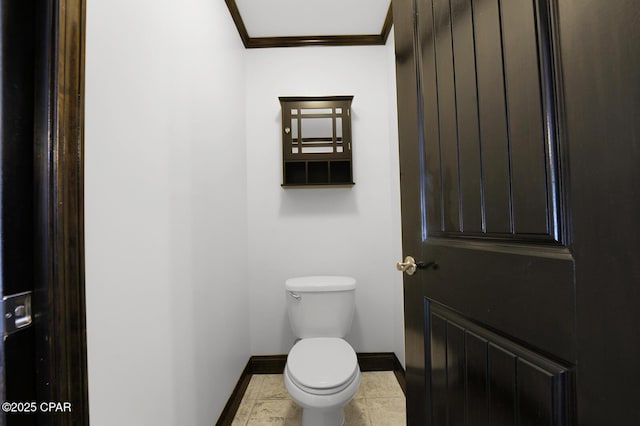 8508 S Holland Rd, Southport, FL 32409 - bathroom with baseboards, toilet, and ornamental molding