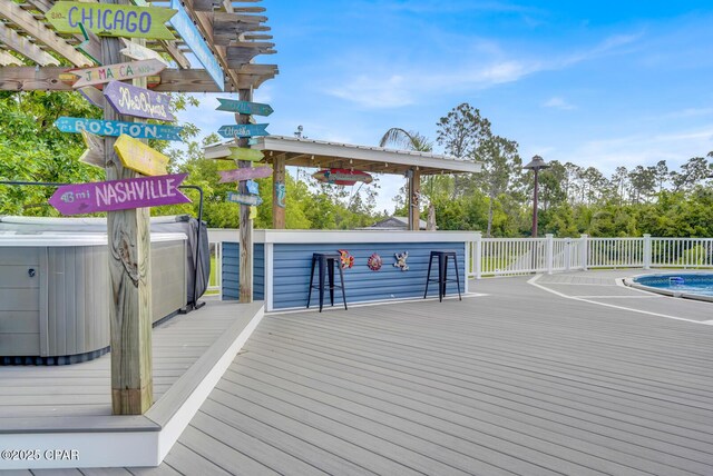 8508 S Holland Rd, Southport, FL 32409 - surrounding community with a jacuzzi and a wooden deck