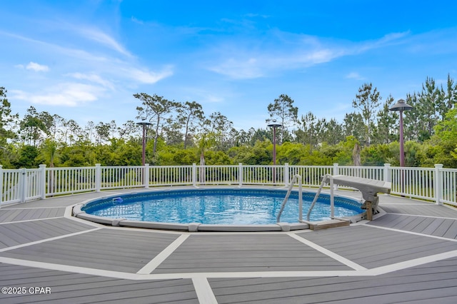 8508 S Holland Rd, Southport, FL 32409 - view of pool with a wooden deck and view of wooded area