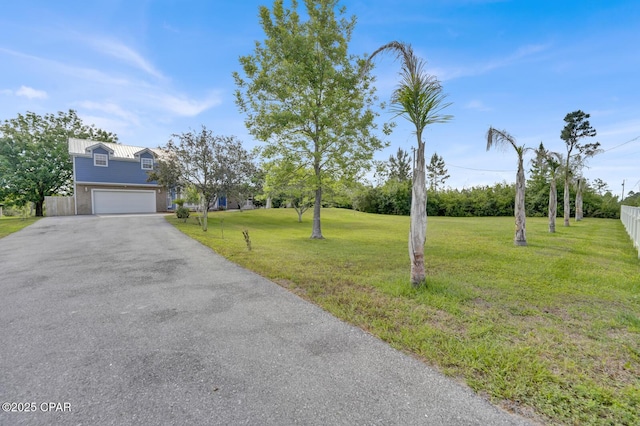 8508 S Holland Rd, Southport, FL 32409 - view of yard featuring driveway and an attached garage