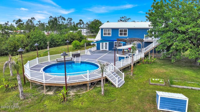 8508 S Holland Rd, Southport, FL 32409 - rear view of house featuring a pergola, metal roof, stairway, and a deck