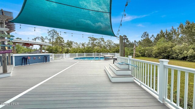 8508 S Holland Rd, Southport, FL 32409 - deck with view of scattered trees and a pool