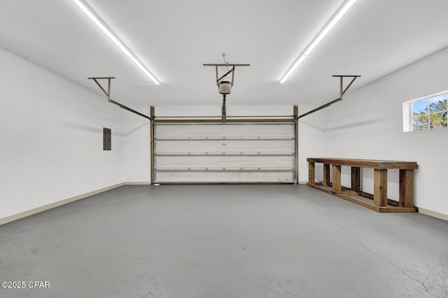 8508 S Holland Rd, Southport, FL 32409 - garage featuring electric panel, baseboards, and a garage door opener