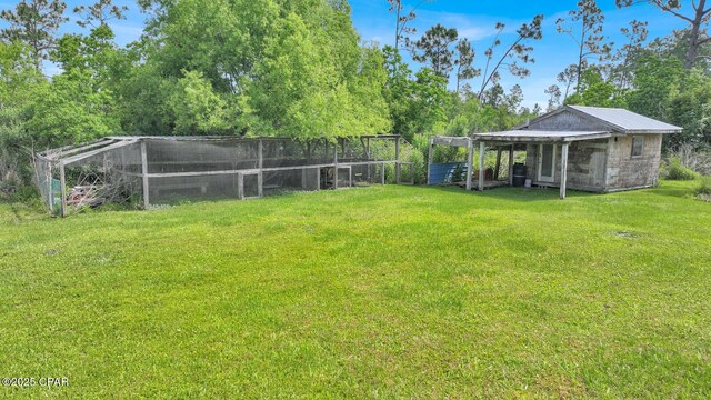 8508 S Holland Rd, Southport, FL 32409 - view of green lawn featuring an outbuilding and exterior structure