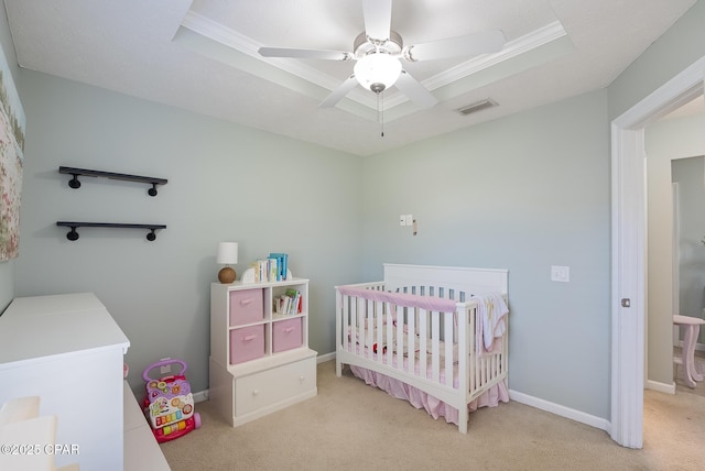 3543 Brentwood Pl, Panama City, FL 32404 - bedroom featuring a nursery area, light carpet, a tray ceiling, ornamental molding, and baseboards