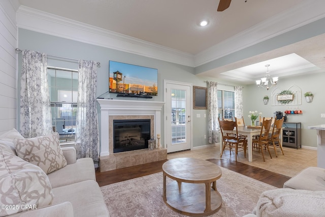 3543 Brentwood Pl, Panama City, FL 32404 - living area with ornamental molding, a tile fireplace, wood finished floors, a chandelier, and baseboards