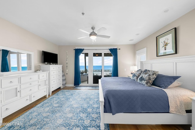 bedroom with access to outside, wood finished floors, and ceiling fan
