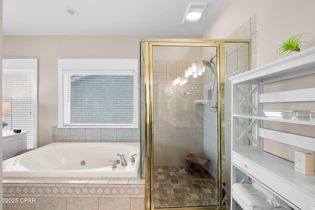 bathroom featuring a shower stall and a tub with jets