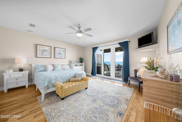 bedroom featuring access to outside, light wood finished floors, and ceiling fan