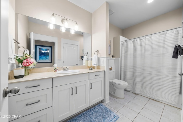 full bath featuring tile patterned floors, toilet, vanity, and curtained shower