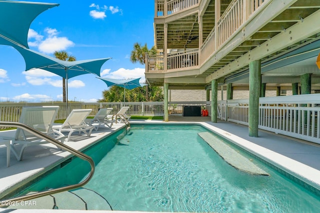 view of pool featuring a patio area and fence