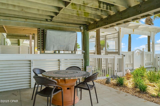 view of patio / terrace featuring fence and outdoor dining space