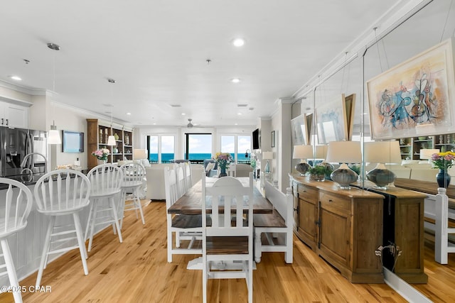 dining space with ornamental molding, ceiling fan, recessed lighting, and light wood-style flooring