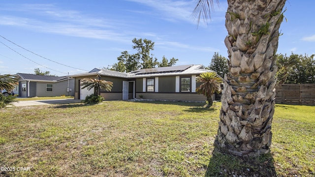722 E Pine Forest Dr, Lynn Haven, FL 32444 - ranch-style home with an attached garage, roof mounted solar panels, metal roof, and concrete driveway