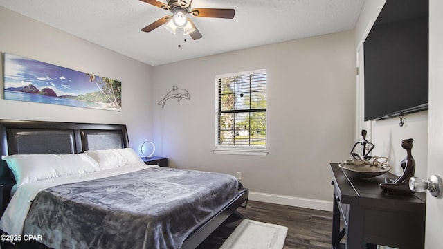 722 E Pine Forest Dr, Lynn Haven, FL 32444 - bedroom with dark wood finished floors, baseboards, and ceiling fan