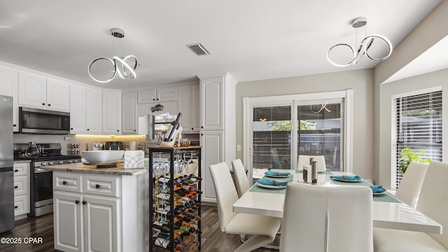 722 E Pine Forest Dr, Lynn Haven, FL 32444 - kitchen with stainless steel appliances, a chandelier, a kitchen island, and healthy amount of natural light