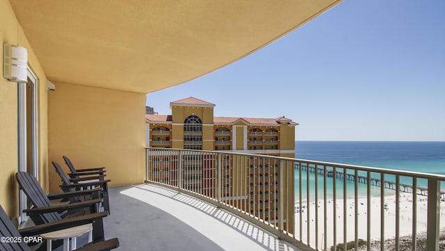 balcony with view of water and beach