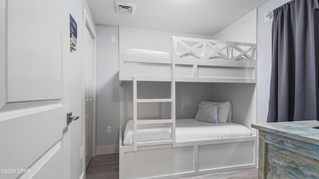 bedroom featuring wood finished floors and baseboards