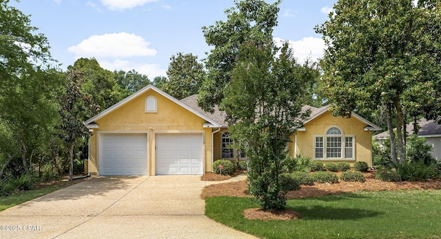 ranch-style house with stucco siding, concrete driveway, an attached garage, and a front lawn