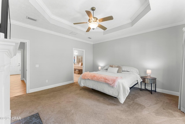 carpeted bedroom featuring a raised ceiling, crown molding, baseboards, and ceiling fan