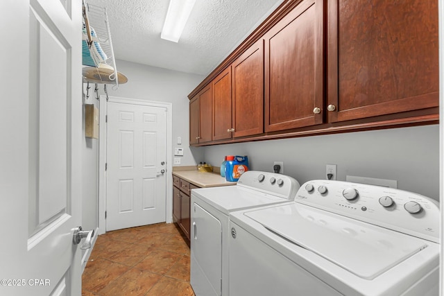washroom featuring cabinet space, separate washer and dryer, and a textured ceiling