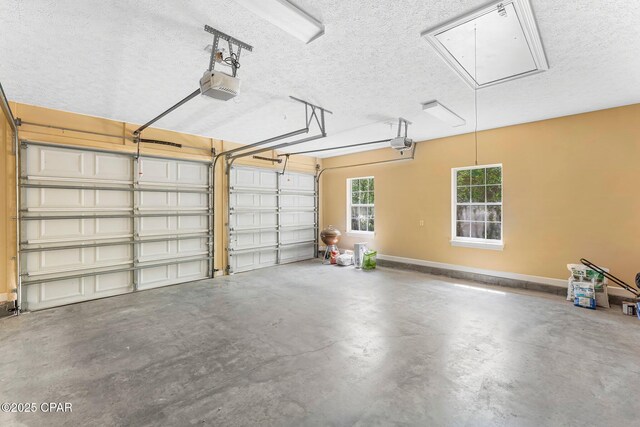 garage with a garage door opener and baseboards