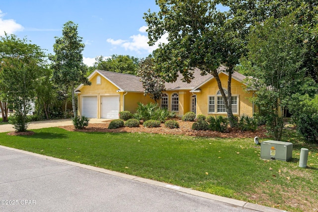 single story home with an attached garage, stucco siding, and a front yard
