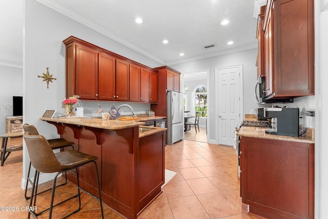 kitchen featuring appliances with stainless steel finishes, ornamental molding, a sink, light stone countertops, and recessed lighting