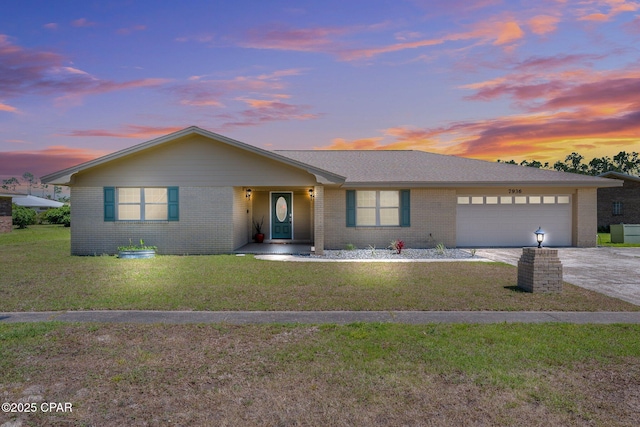 7936 Betty Louise Dr, Panama City, FL 32404 - ranch-style home featuring brick siding, an attached garage, concrete driveway, and a front lawn