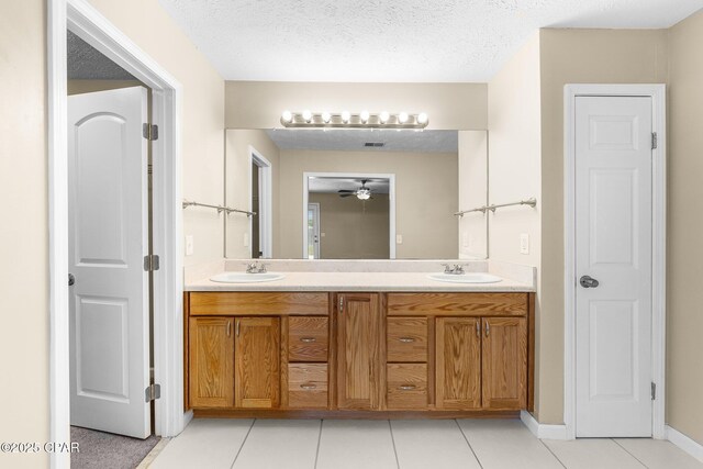 7936 Betty Louise Dr, Panama City, FL 32404 - full bath with tile patterned floors, double vanity, a textured ceiling, and a ceiling fan