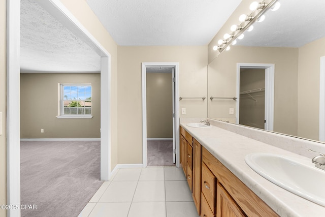 7936 Betty Louise Dr, Panama City, FL 32404 - full bath featuring a textured ceiling, baseboards, double vanity, and tile patterned flooring