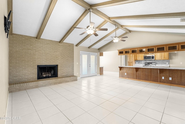 7936 Betty Louise Dr, Panama City, FL 32404 - unfurnished living room with a ceiling fan, a fireplace, high vaulted ceiling, beamed ceiling, and french doors
