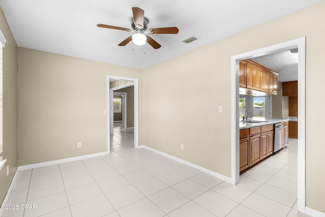 7936 Betty Louise Dr, Panama City, FL 32404 - spare room featuring a ceiling fan, a sink, light tile patterned floors, and baseboards