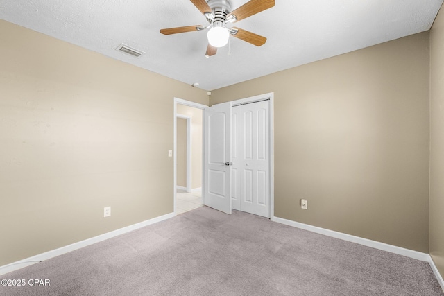 7936 Betty Louise Dr, Panama City, FL 32404 - unfurnished bedroom with light colored carpet, a closet, baseboards, and ceiling fan