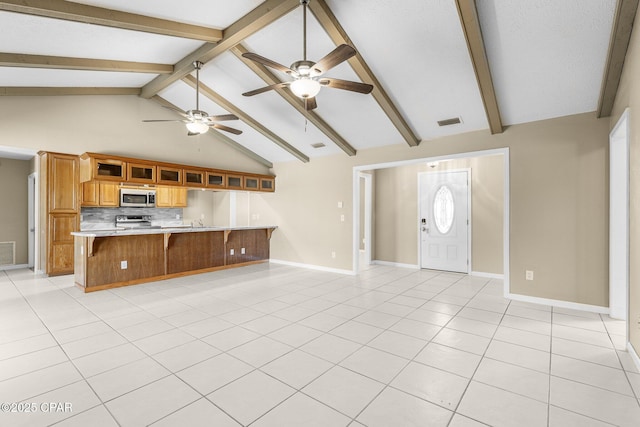 7936 Betty Louise Dr, Panama City, FL 32404 - unfurnished living room featuring a ceiling fan, beam ceiling, baseboards, high vaulted ceiling, and light tile patterned flooring