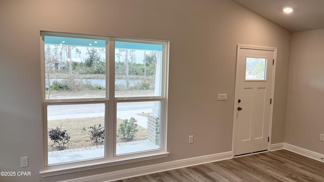 11438 Palm Breeze St, Panama City, FL 32404 - foyer with wood finished floors, baseboards, a water view, vaulted ceiling, and recessed lighting