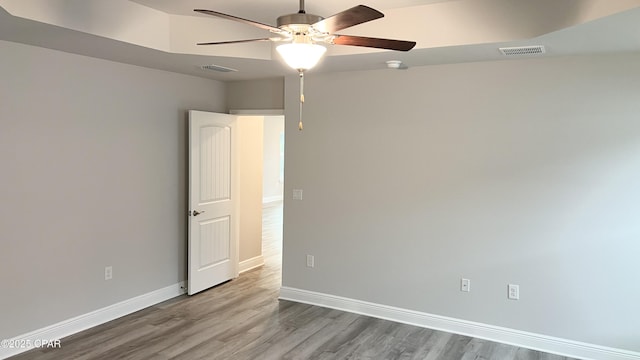 11438 Palm Breeze St, Panama City, FL 32404 - empty room with ceiling fan, wood finished floors, and baseboards