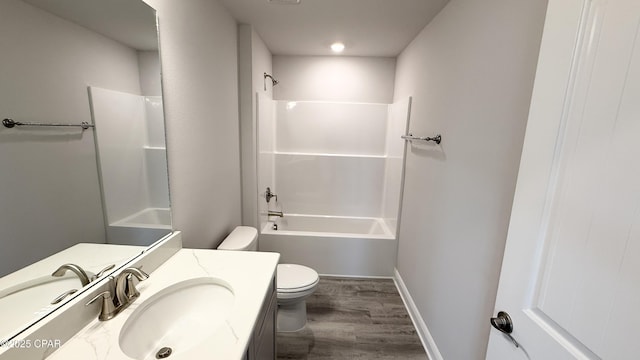 11442 Palm Breeze St, Panama City, FL 32404 - bathroom featuring toilet, vanity, wood finished floors, bathing tub / shower combination, and baseboards