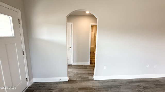 11442 Palm Breeze St, Panama City, FL 32404 - empty room featuring arched walkways, dark wood-style floors, and baseboards