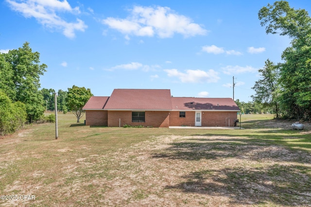 10367 NW County Road 274, Altha, FL 32421 - back of house featuring a yard and brick siding