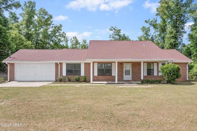10367 NW County Road 274, Altha, FL 32421 - view of front of home with an attached garage, concrete driveway, brick siding, and a front yard