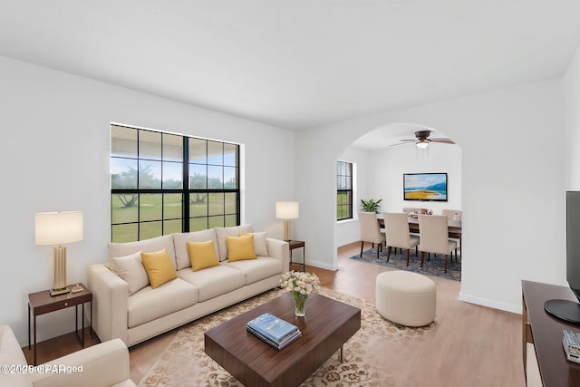 10367 NW County Road 274, Altha, FL 32421 - living room featuring wood finished floors, arched walkways, ceiling fan, and baseboards