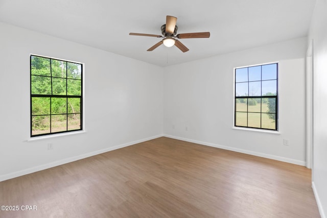 10367 NW County Road 274, Altha, FL 32421 - spare room featuring healthy amount of natural light, wood finished floors, and a ceiling fan