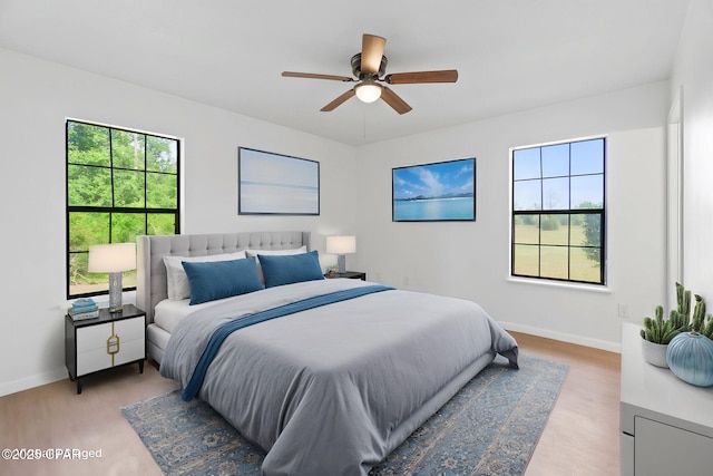 10367 NW County Road 274, Altha, FL 32421 - bedroom featuring multiple windows, baseboards, and light wood-style floors