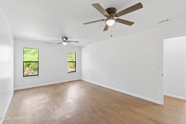 10367 NW County Road 274, Altha, FL 32421 - unfurnished room with light wood-style floors, a ceiling fan, and baseboards