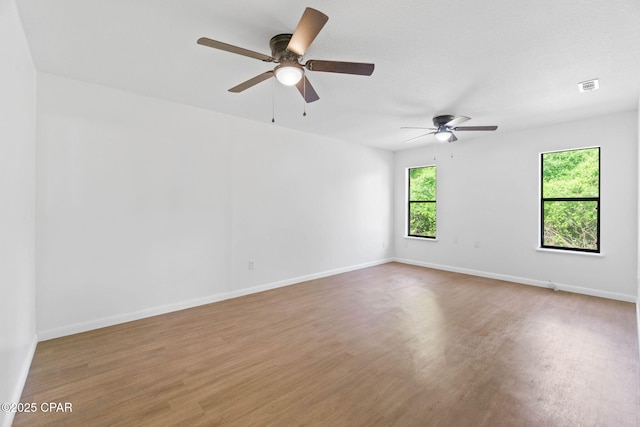 10367 NW County Road 274, Altha, FL 32421 - spare room with wood finished floors, a ceiling fan, and baseboards