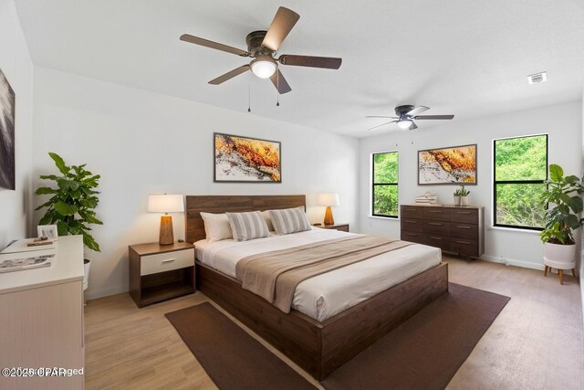 10367 NW County Road 274, Altha, FL 32421 - bedroom featuring light wood finished floors, baseboards, and ceiling fan